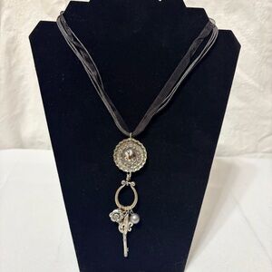 Handmade, artisan charm necklace with a bottle cap pendant and metal charms